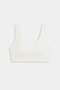 The SPLITS59 Airweight Rib Bra in white features wide straps and a scoop neckline, crafted from ribbed airweight fabric for comfort—ideal for hot yoga. Shown laid flat on a plain light background.