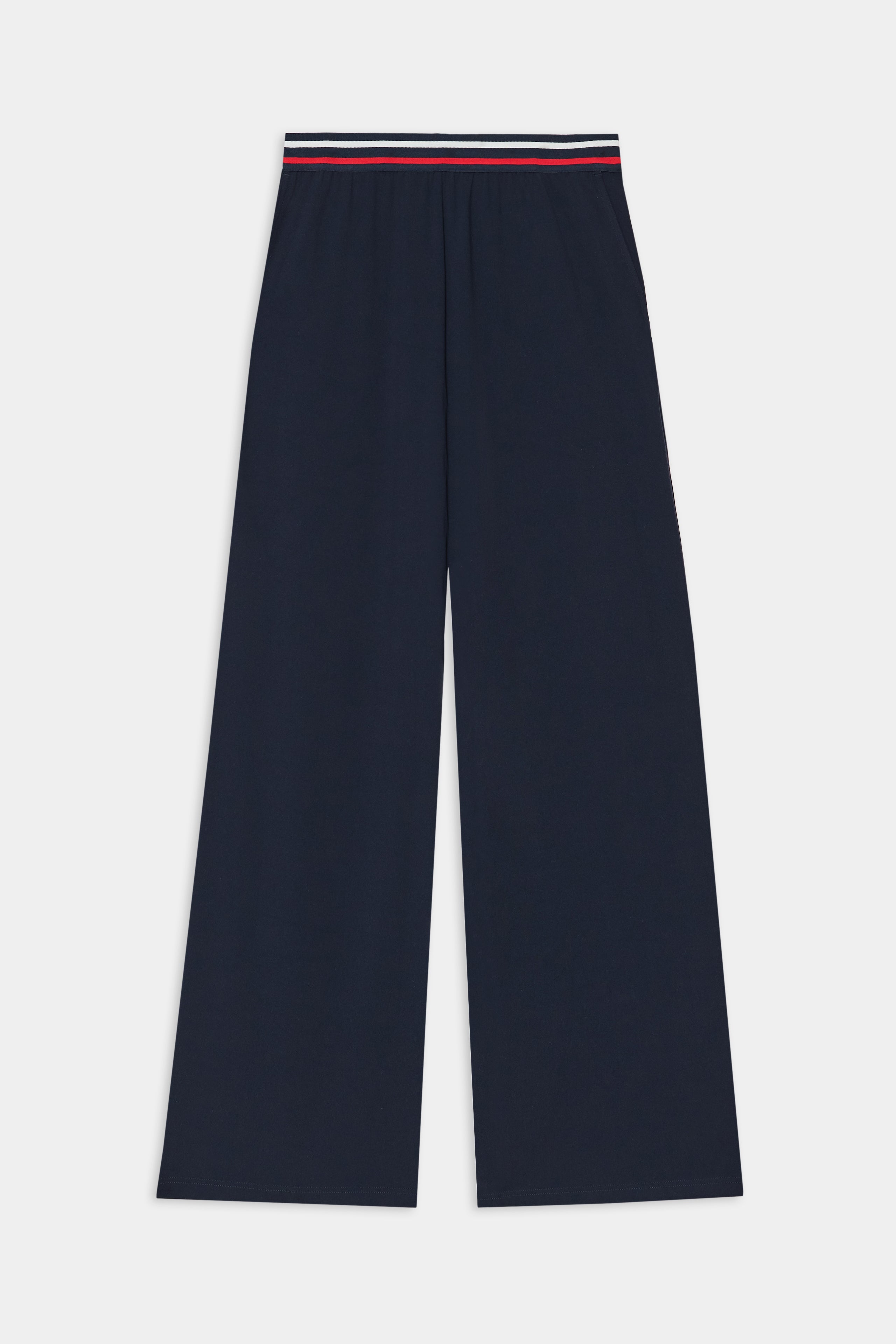 The SPLITS59 Michele Airweight Trouser in indigo features wide legs and an elastic waistband with red, white, and blue stripe detail, shown flat on a white background.