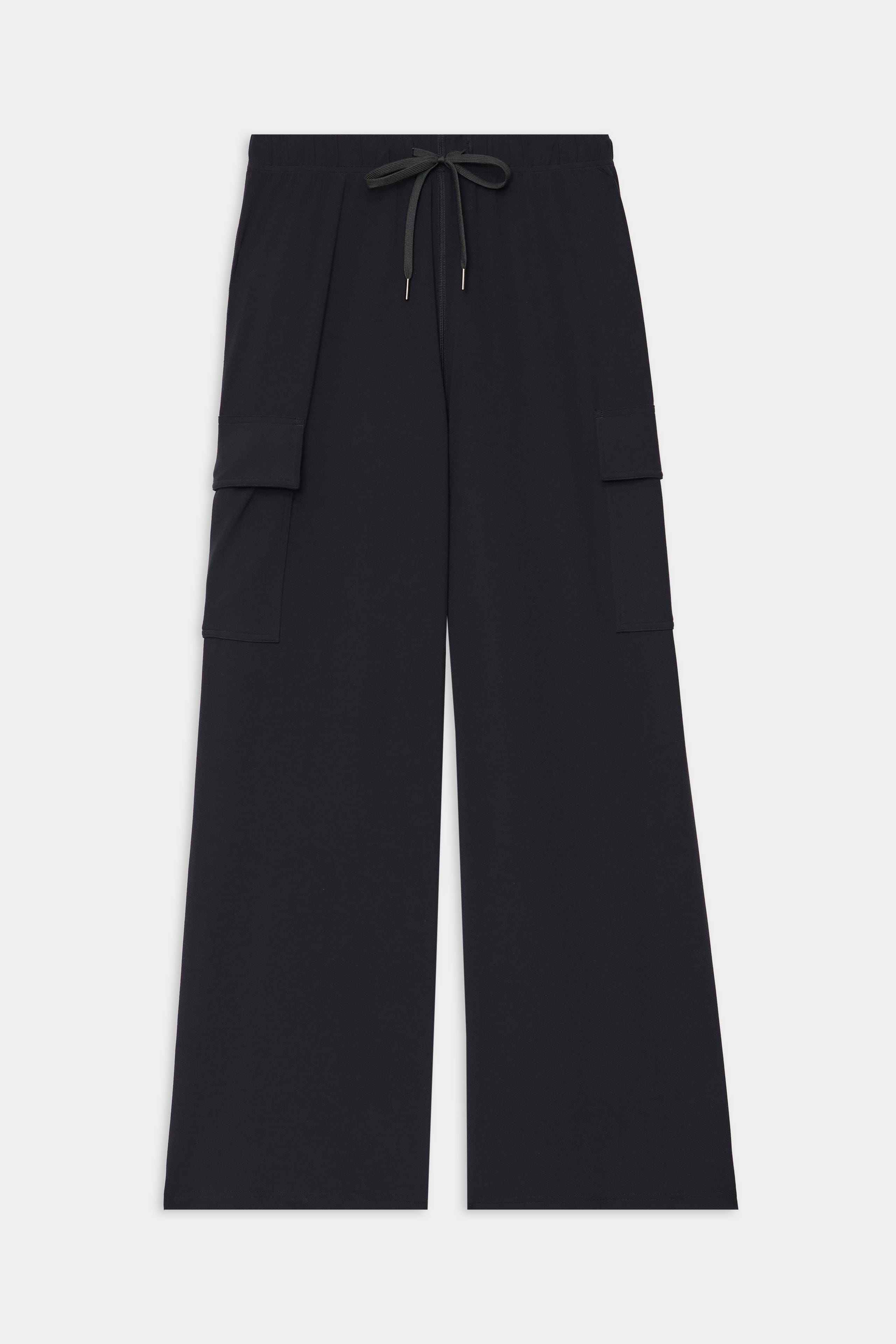 The Alex Airweight Cargo Pant in Black by SPLITS59 features a wide-leg fit, elastic waistband with drawstring tie, and side flap pockets, crafted from lightweight Airweight fabric and shown laid flat on a white background.