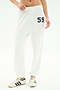 A person wears SPLITS59's Andie Oversized Fleece Varsity 59 Sweatpant in White/59, featuring the number 59 on the left hip, paired with white sneakers with black stripes—ideal for cool weather workouts—against a plain white background.