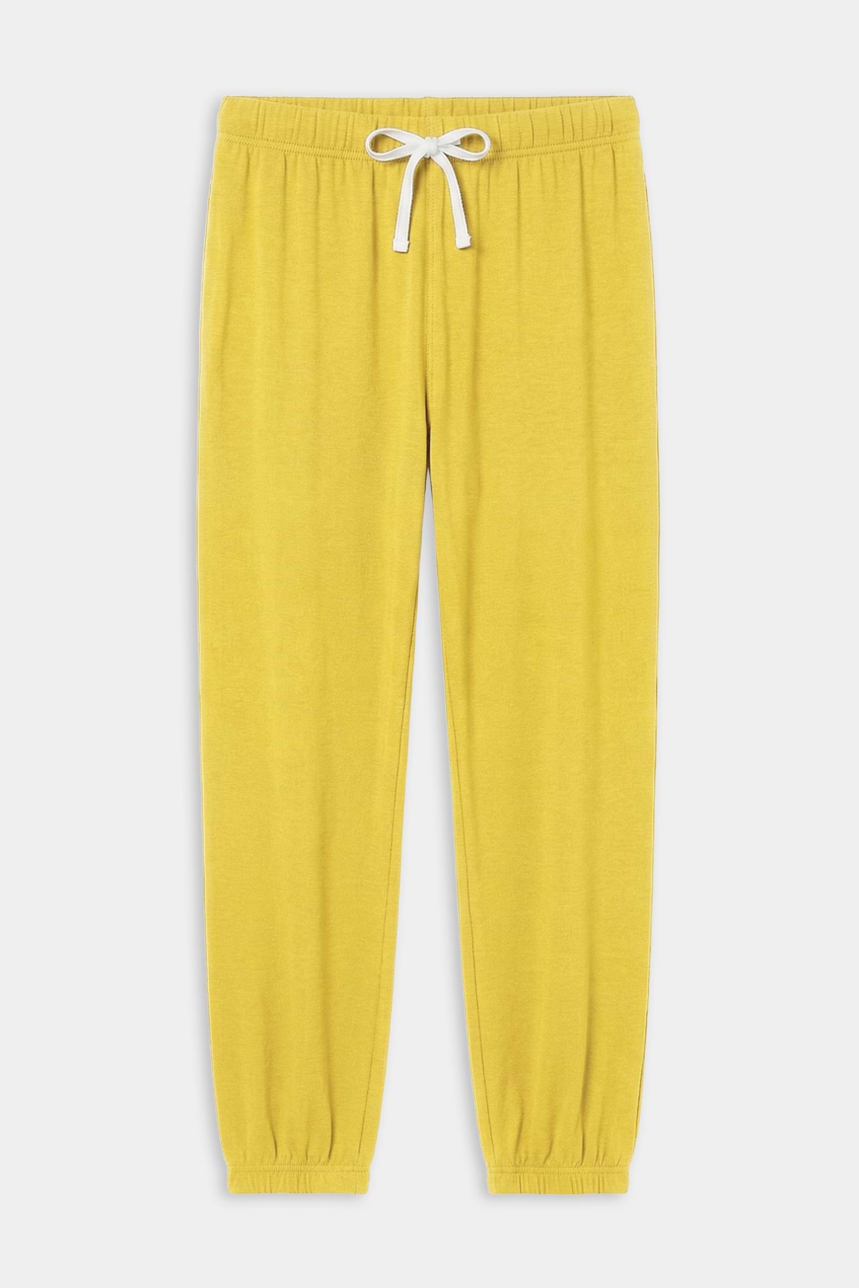 The SPLITS59 Andie Oversized Fleece Sweatpant in Bright Yellow features an elastic waistband, white drawstring, and elastic cuffs—ideal for cool weather workouts. Expertly made in Los Angeles and shown laid flat on a white background.