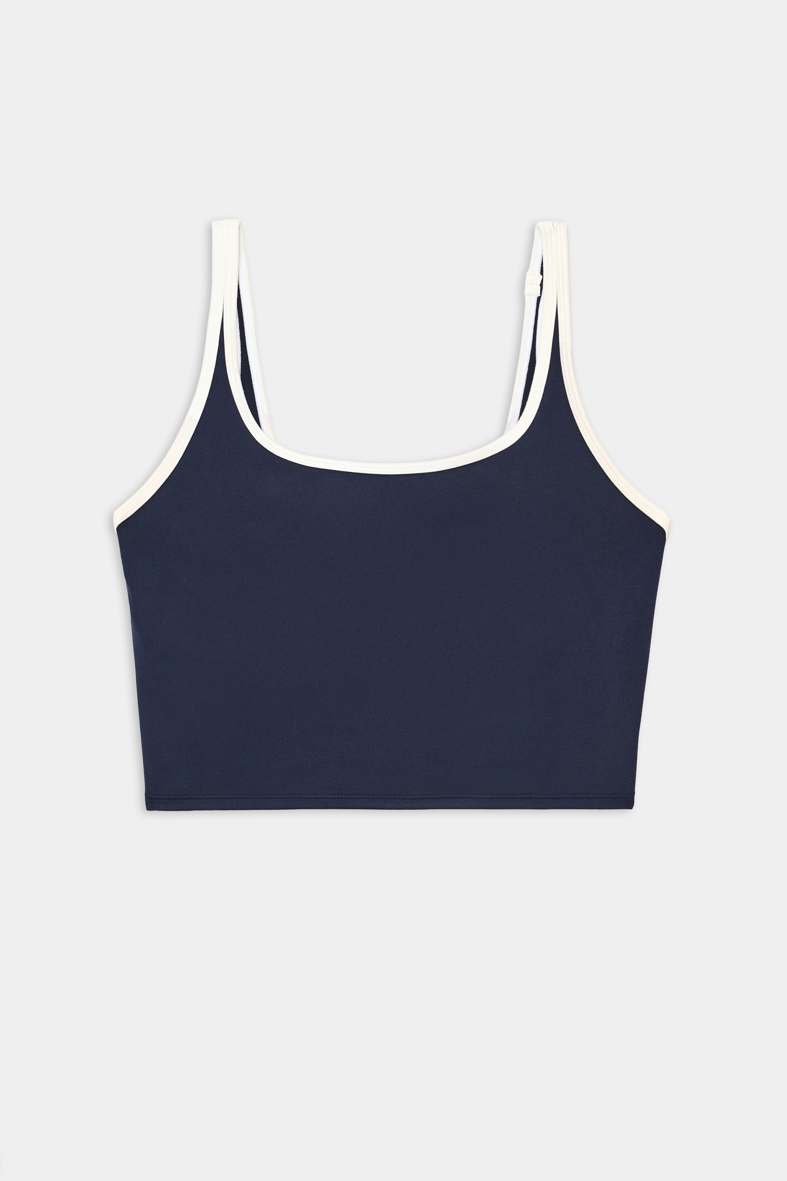 The SPLITS59 Cait Rigor Bralette in Indigo/White features white trim on the straps and neckline and is crafted from soft nylon spandex fabric, shown against a plain white background.