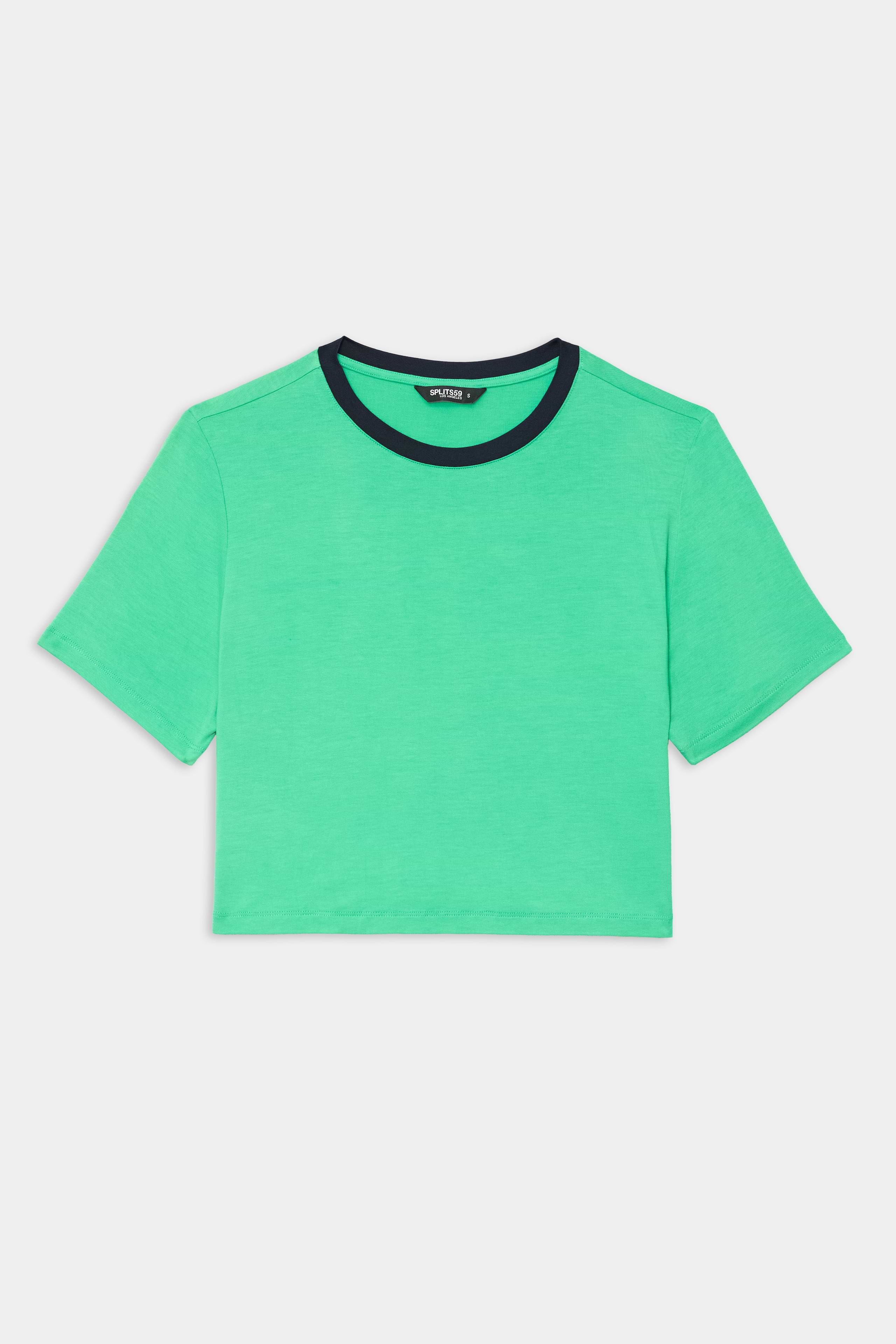 The SPLITS59 Djuna Crop Ringer in Spearmint/Indigo is a green short-sleeve crop top with a black crew neckline, made from a soft viscose blend, shown laid flat on a white background.