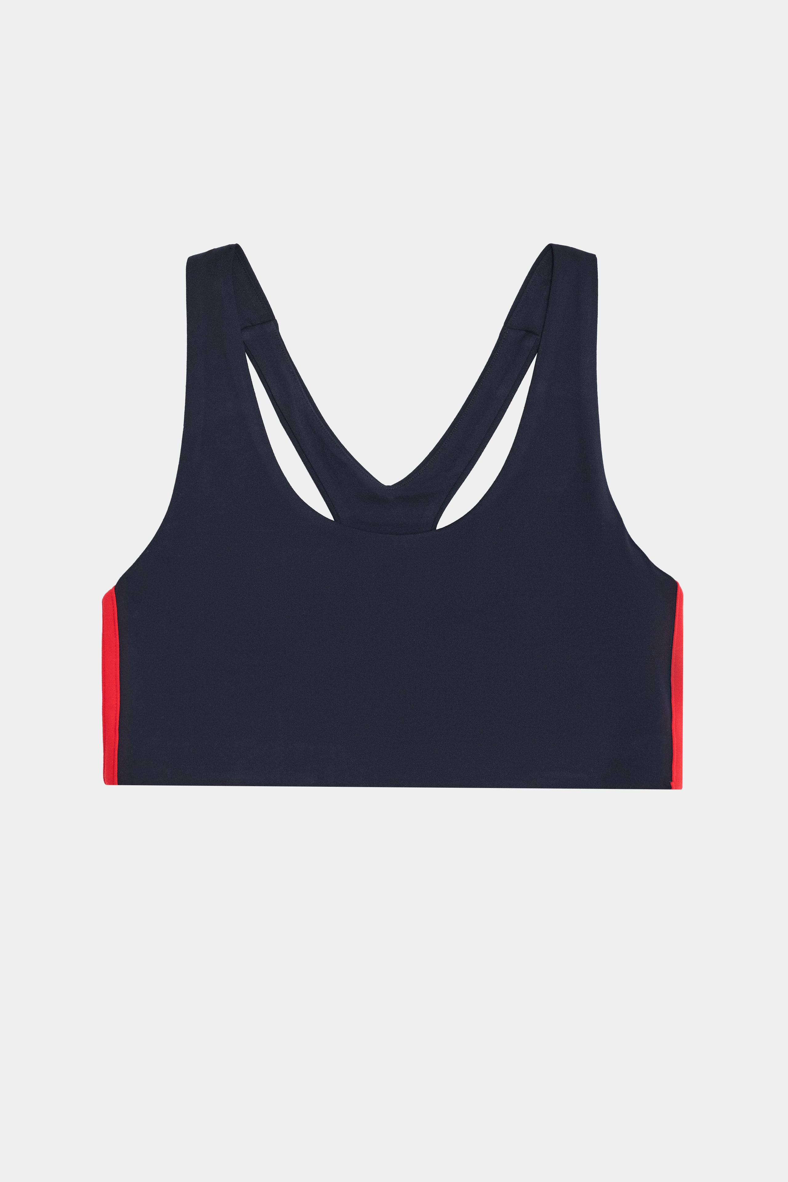 The SPLITS59 Ella Airweight Bra in Indigo/Pirate Red features a racerback design with red side panels, perfect for hot yoga, and is displayed on a plain white background.