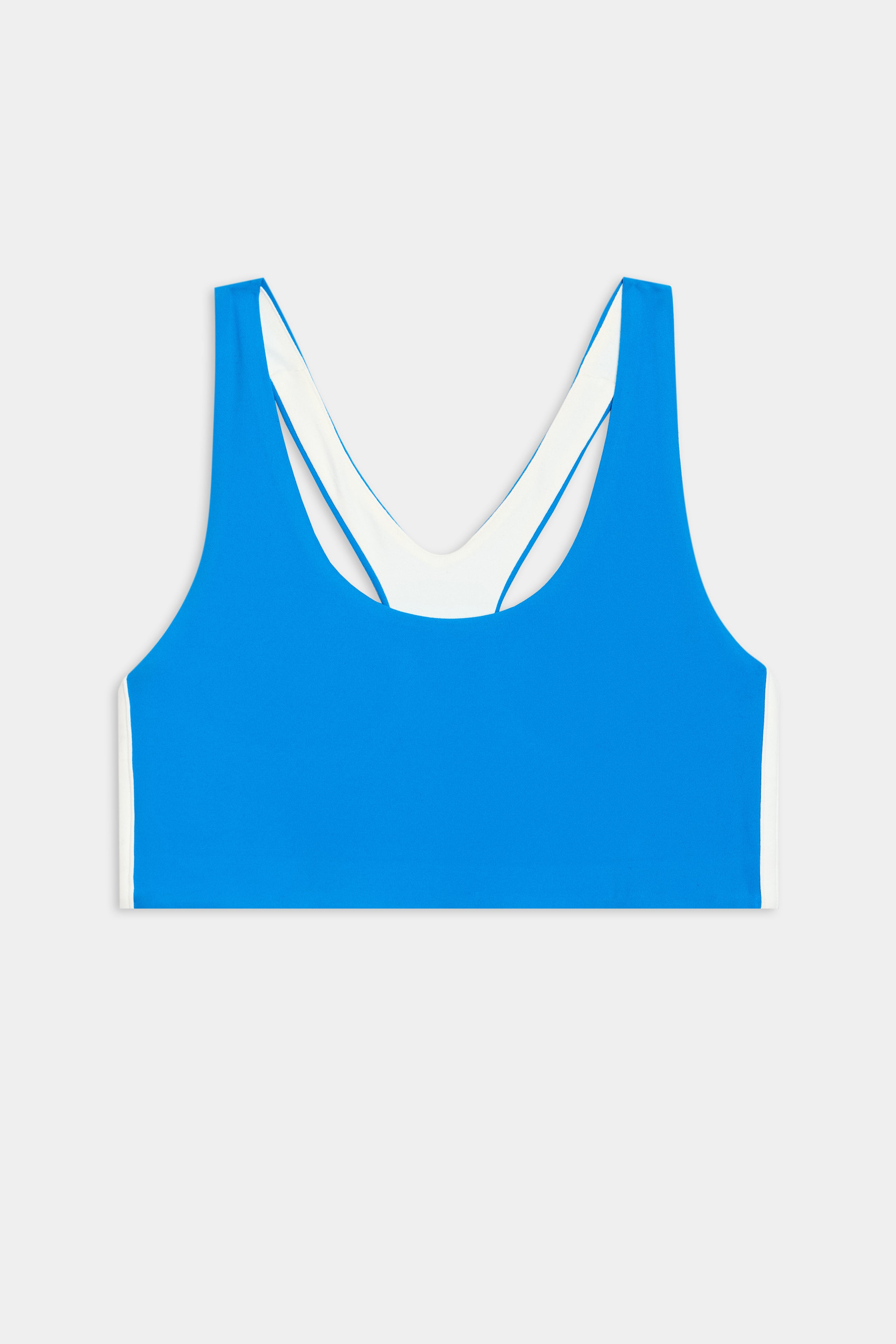 The SPLITS59 Ella Airweight Bra in Riviera/White, featuring a racer back and white inner lining, is ideal for Pilates and shown laid flat against a plain white background.