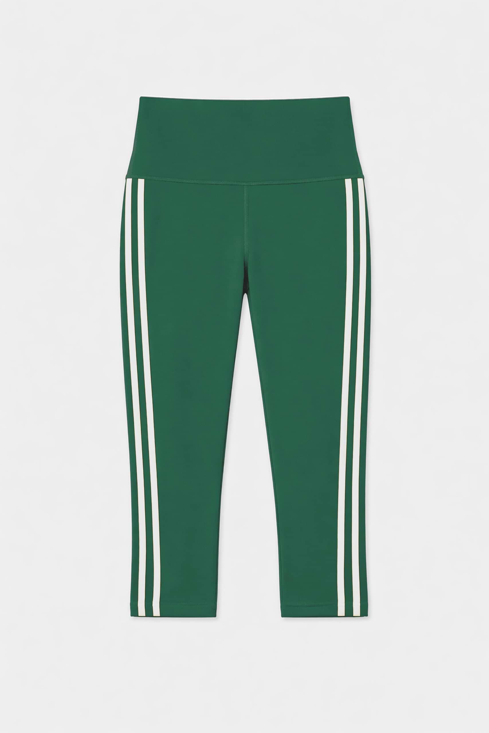 The SPLITS59 Ella High Waist Airweight Capri in Arugula/White features a cropped silhouette, high waistband, and two vertical white side stripes, shown against a plain white background.