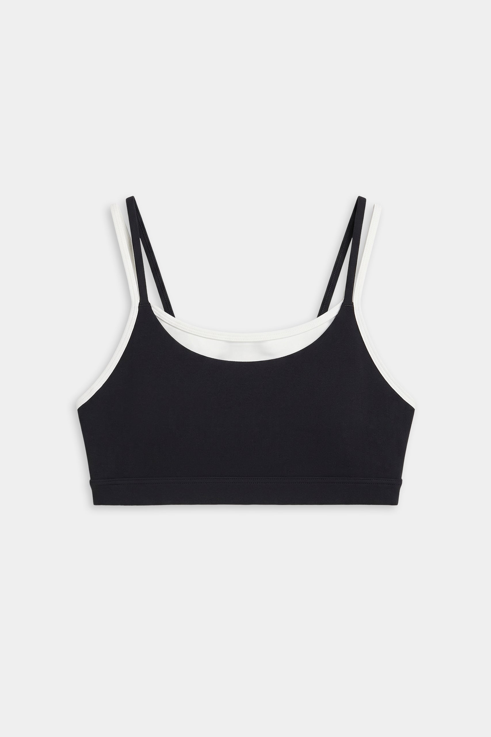 The SPLITS59 Elliah Airweight Double Layer Bra in black/white features double shoulder straps, white trim, and a soft spandex-nylon blend, shown on a plain white background.