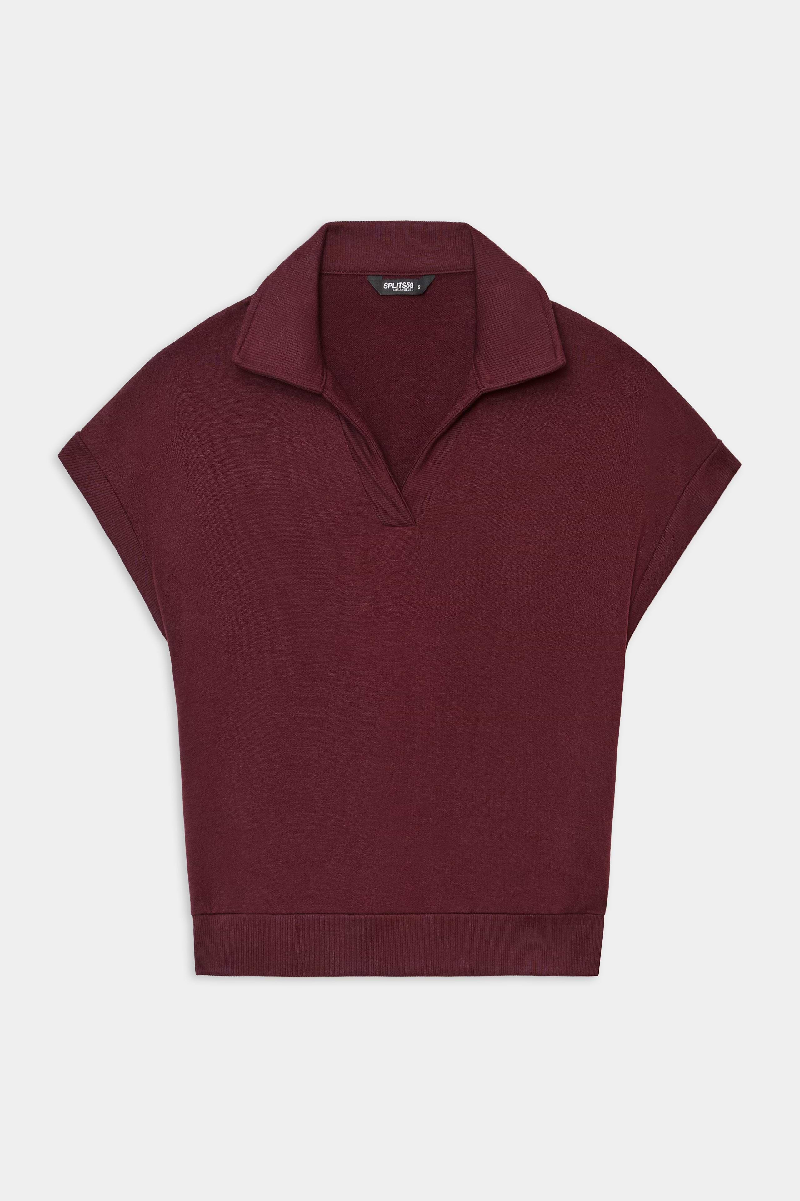 The SPLITS59 Evie Fleece Sleeveless Polo in Dark Cherry, featuring a collared neckline and relaxed fit in soft modal fabric, is shown laid flat on a white background.