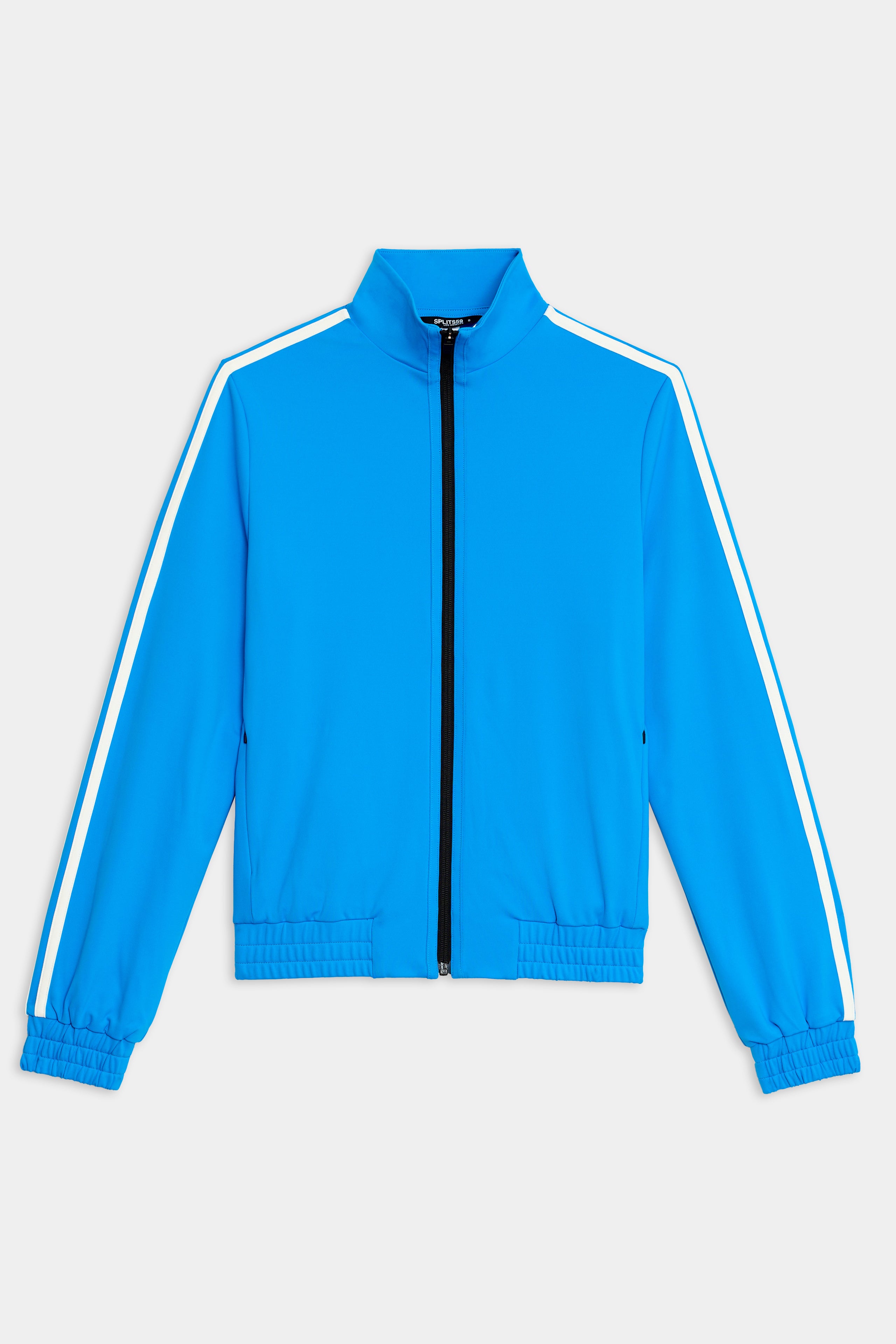 The SPLITS59 Fox Techflex Jacket is a blue zip-up track jacket with white stripes on the shoulders and sleeves, black zipper, and elastic cuffs and hem.