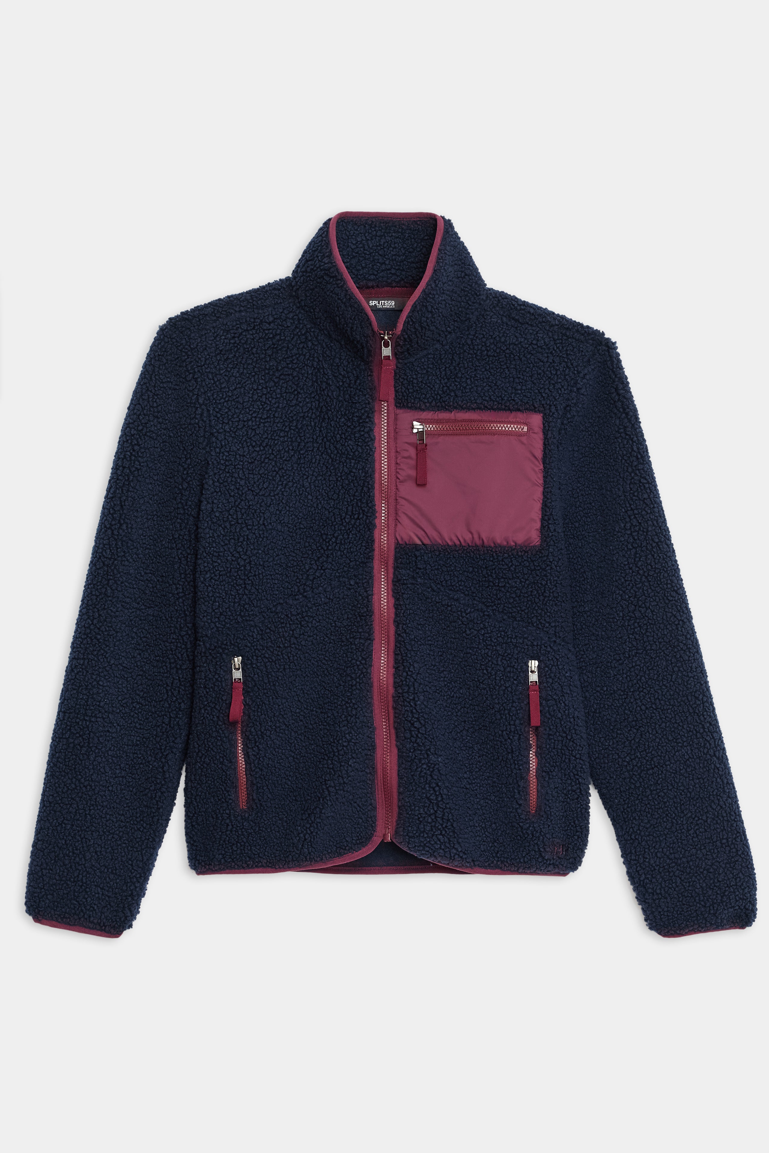 The SPLITS59 Harris Sherpa Jacket features navy blue fleece with a maroon zipper, trim, and chest pocket, shown against a plain white background.