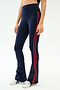 A person wears the SPLITS59 Raquel High Waist Flared Legging in Indigo/Lotus Red with white sneakers, standing against a plain white background. These stylish leggings offer comfortable 4-way stretch for easy movement.