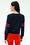 A person with long dark hair wears the SPLITS59 Brooks Stripe Fleece Sweatshirt in Indigo/Lotus Red, facing away from the camera against a plain background.