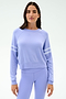A woman wears the SPLITS59 Brooks Stripe Fleece Sweatshirt, a light purple long-sleeve top with two white sleeve stripes, paired with matching leggings, standing against a plain light background.