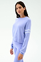 A woman wears the SPLITS59 Brooks Stripe Fleece Sweatshirt in Purple Haze/White—featuring two white sleeve stripes—paired with matching leggings, made from drape-stretch modal, standing against a plain white background.