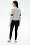 A woman stands facing away, wearing the SPLITS59 Brooks Stripe Fleece Sweatshirt in Heather Grey/Black, paired with black leggings and white sneakers, set against a plain white background.