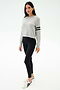 A woman in the SPLITS59 Brooks Stripe Fleece Sweatshirt in Heather Grey/Black and black leggings, crafted from drape-stretch modal fabric and made in Los Angeles.