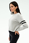 A woman in profile wears the SPLITS59 Brooks Stripe Fleece Sweatshirt in Heather Grey/Black with two black sleeve stripes and black leggings, crafted from drape-stretch modal, standing against a plain background.