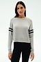 A woman faces forward in a SPLITS59 Brooks Stripe Fleece Sweatshirt, light grey with black sleeve stripes, paired with black leggings, set against a plain light background.