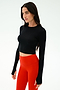 A woman faces slightly left wearing the SPLITS59 Louise Rib Long Sleeve Crop in black with high-waisted red leggings, set against a plain light background.