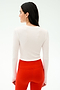 A woman with long dark hair models the SPLITS59 Louise Rib Long Sleeve Crop in white, paired with high-waisted red leggings, shown from the back against a plain white background.
