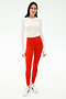 A person stands facing forward in a white long-sleeve top, white sneakers, and SPLITS59 Sprint High Waist Rigor 7/8 leggings in Lotus Red, against a plain white background.