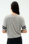A person with long dark hair, seen from the back, wears the SPLITS59 Ava Jersey Tee in Heather Grey/Black and black pants against a plain light backdrop—perfect for gym sessions or CrossFit.