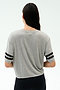 A person with long dark hair, seen from the back, wears the SPLITS59 Ava Jersey Tee in Heather Grey/Black and black pants against a plain light backdrop—perfect for gym sessions or CrossFit.