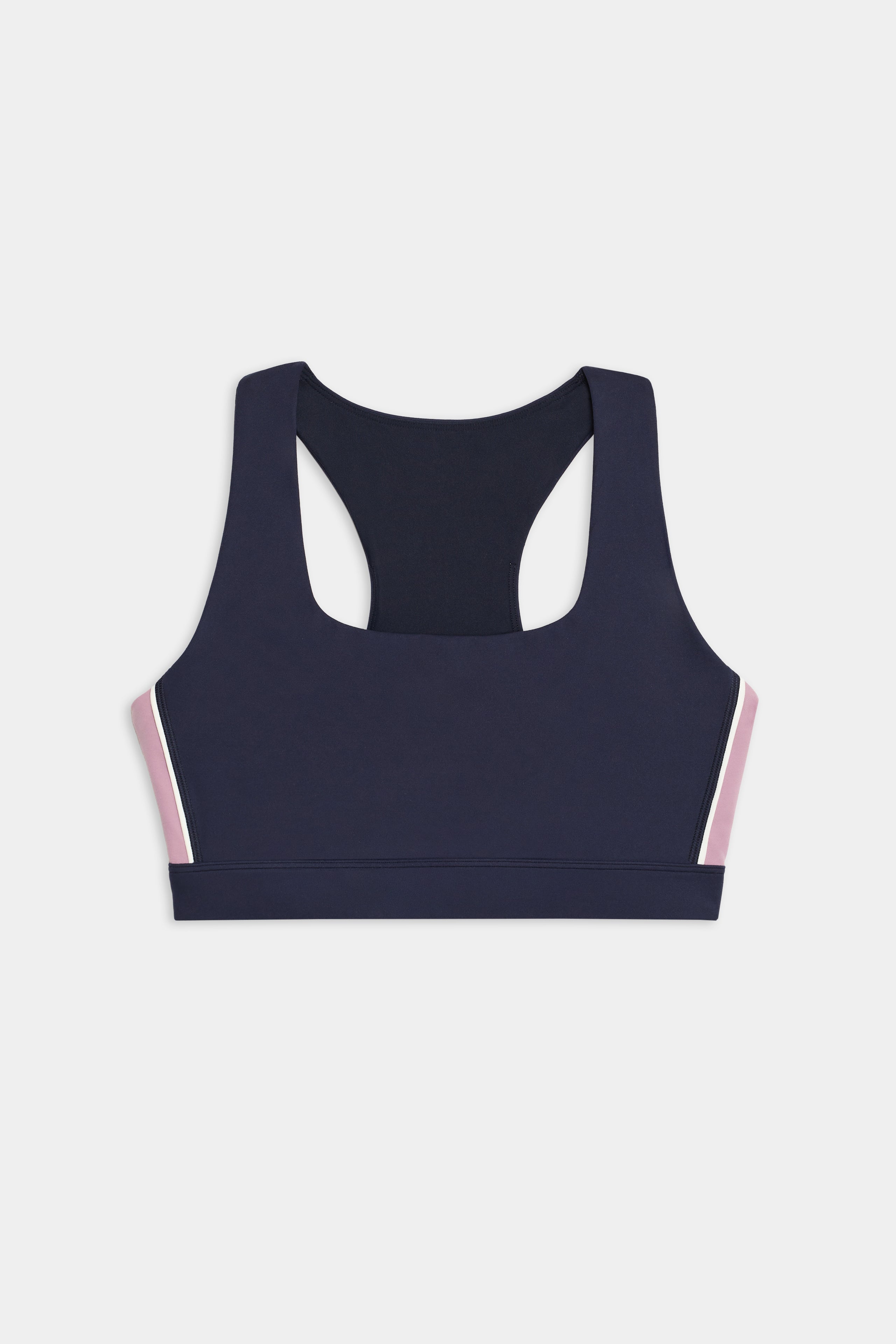 The SPLITS59 Lexi Rigor Bra features a navy blue racerback design with light pink side panels, shown against a white background.