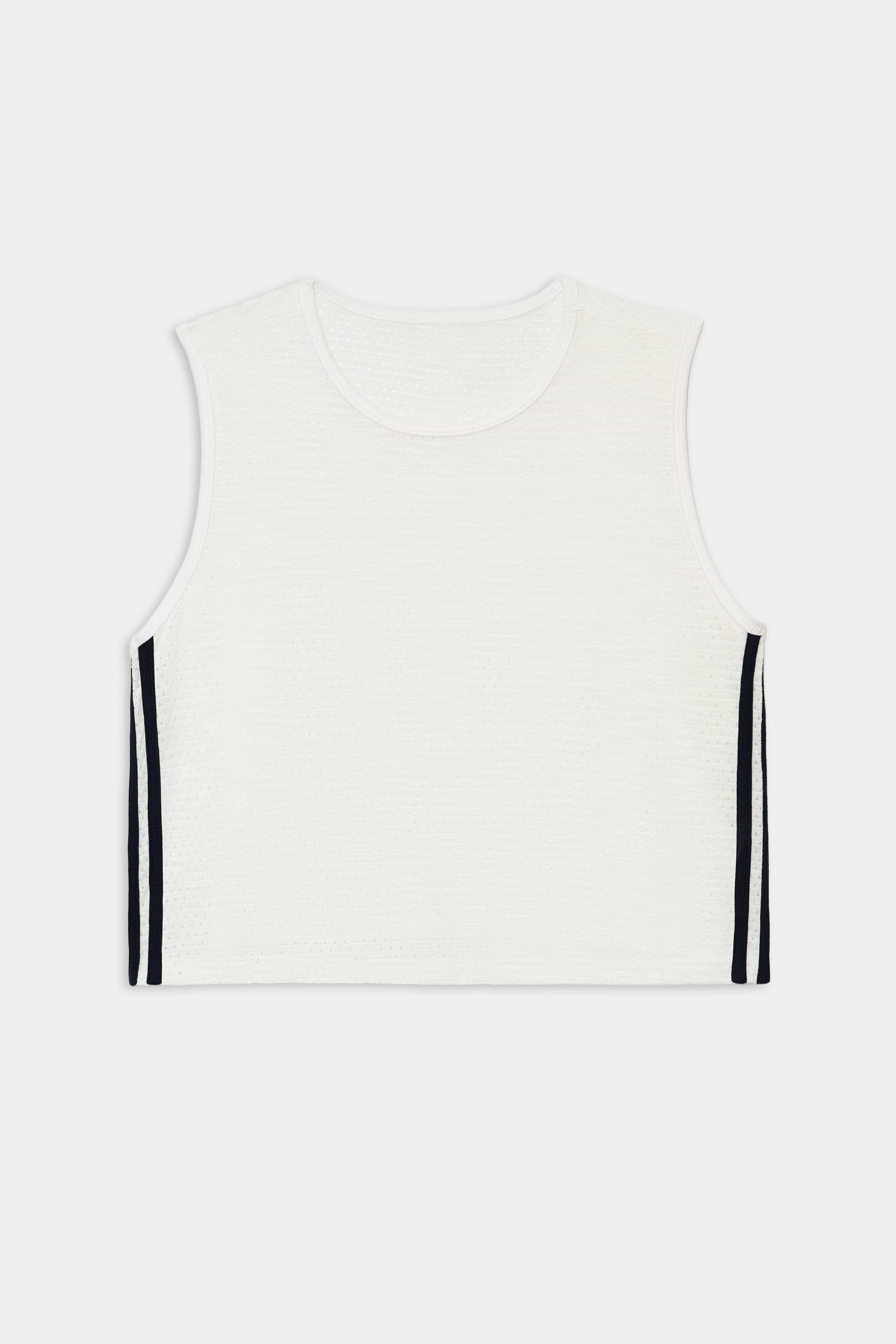 The SPLITS59 Logan Mesh Tank With Stripe in White/Indigo is a sleeveless, white cropped workout top with a round neckline and indigo side stripes, shown on a plain white background.