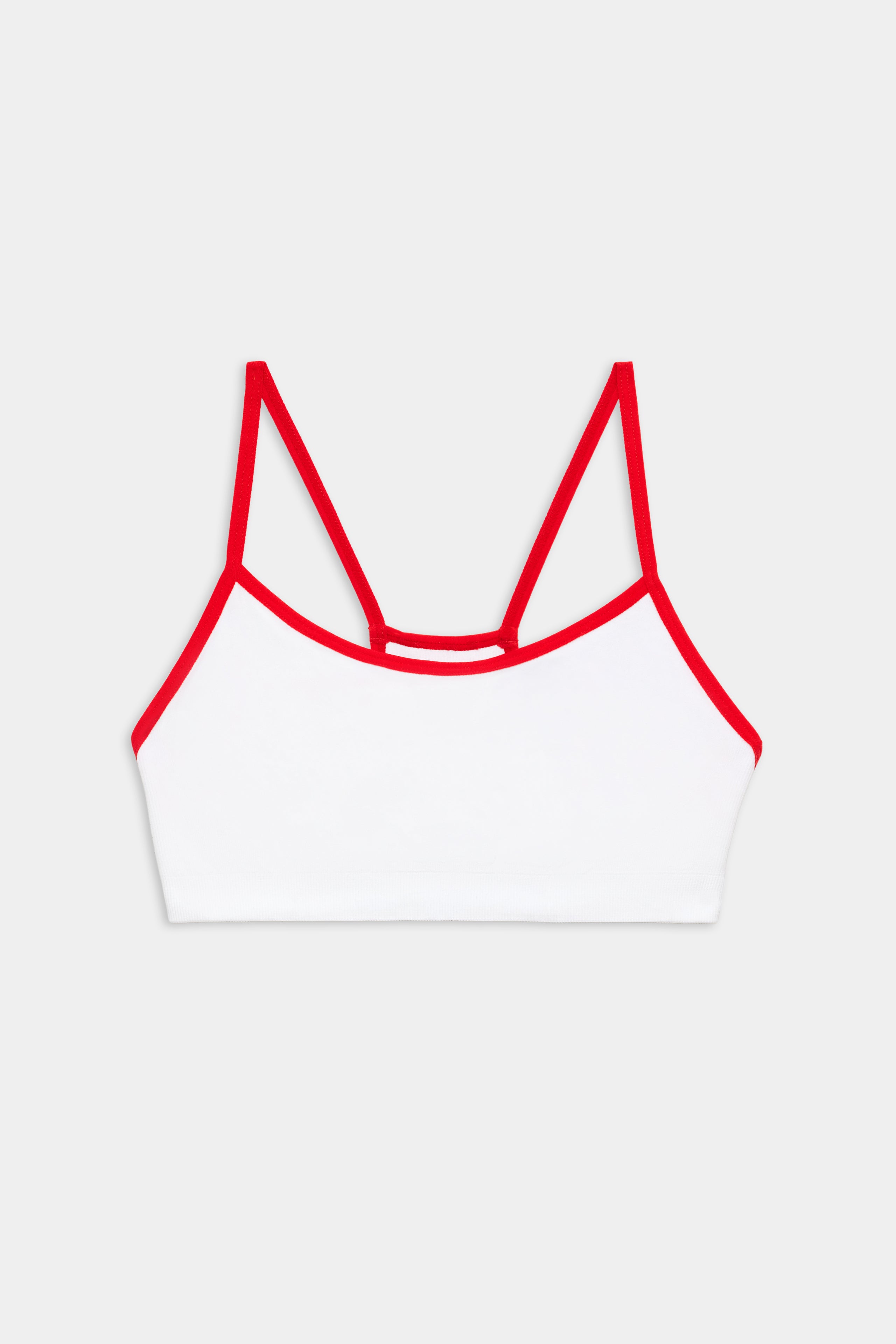 White bralette with thin red straps and red trim, displayed on a plain light gray background.