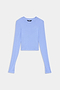 A light blue, long-sleeve, crew neck cropped top is laid flat on a white background.