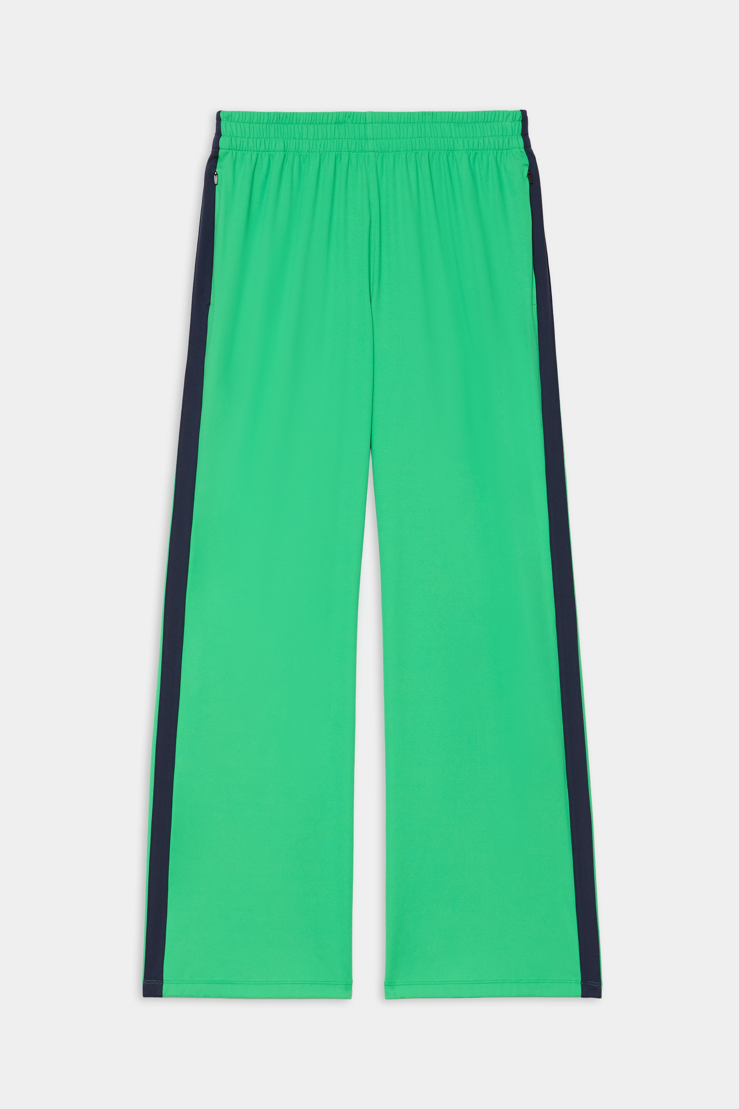 The SPLITS59 Maxie Rigor Trackpant in Grass/Indigo features a bright green wide-leg design, elastic waistband, and dark indigo side stripes, shown laid flat on a white background.