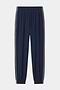 The SPLITS59 Megan Woven Nylon Jogger w/ Piping in Indigo/Creme features an elastic waistband and cuffs, white side piping, and is crafted from stretchy fabric for comfort and flexibility.
