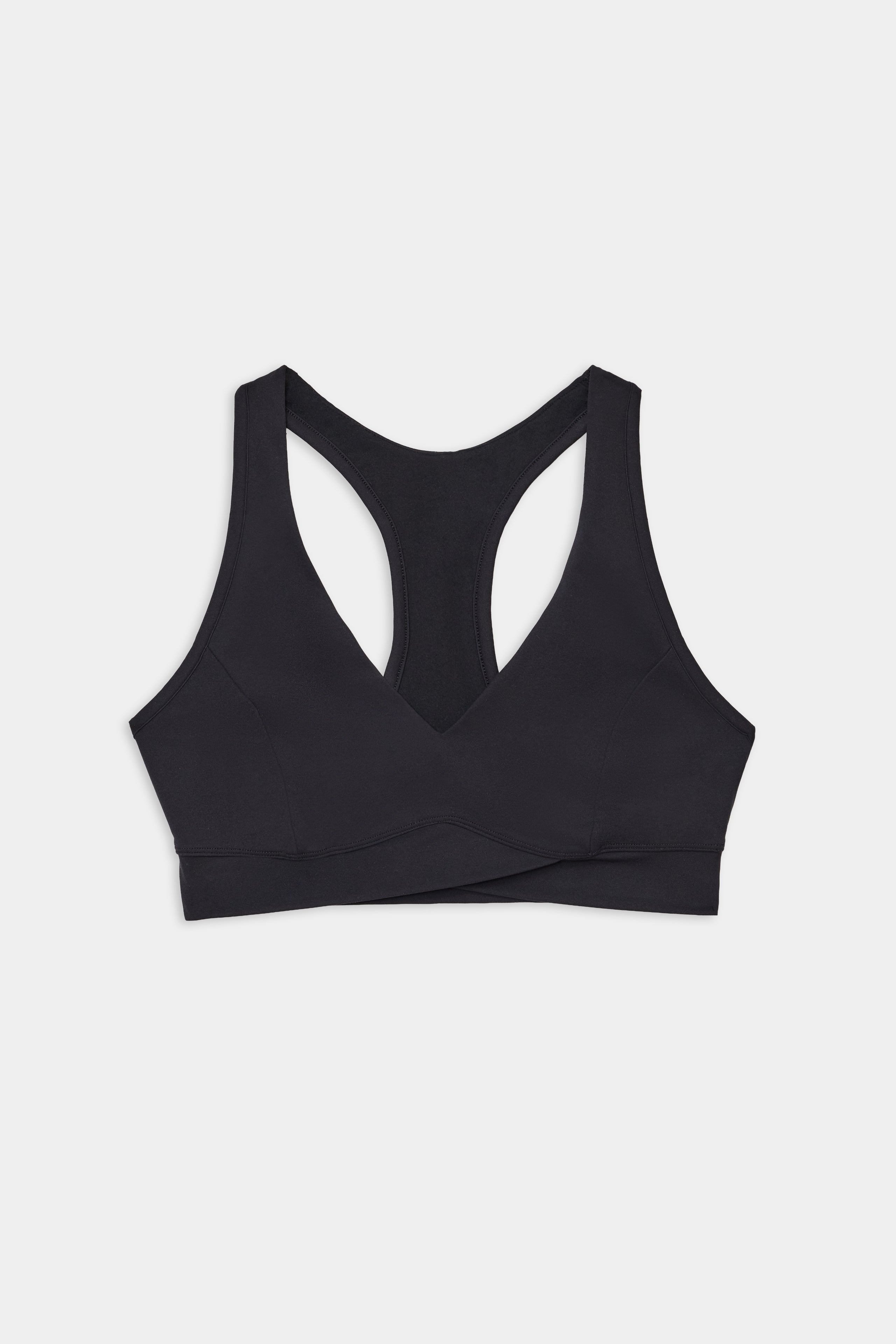 The SPLITS59 Mia Rigor Bra in black features a racerback, wide underband, and crossover front—ideal for gym workouts—shown laid flat on a white background.
