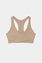The SPLITS59 Mia Rigor Bra in Latte, a beige racerback sports bra crafted from a soft nylon-spandex blend, is laid flat on a white background.