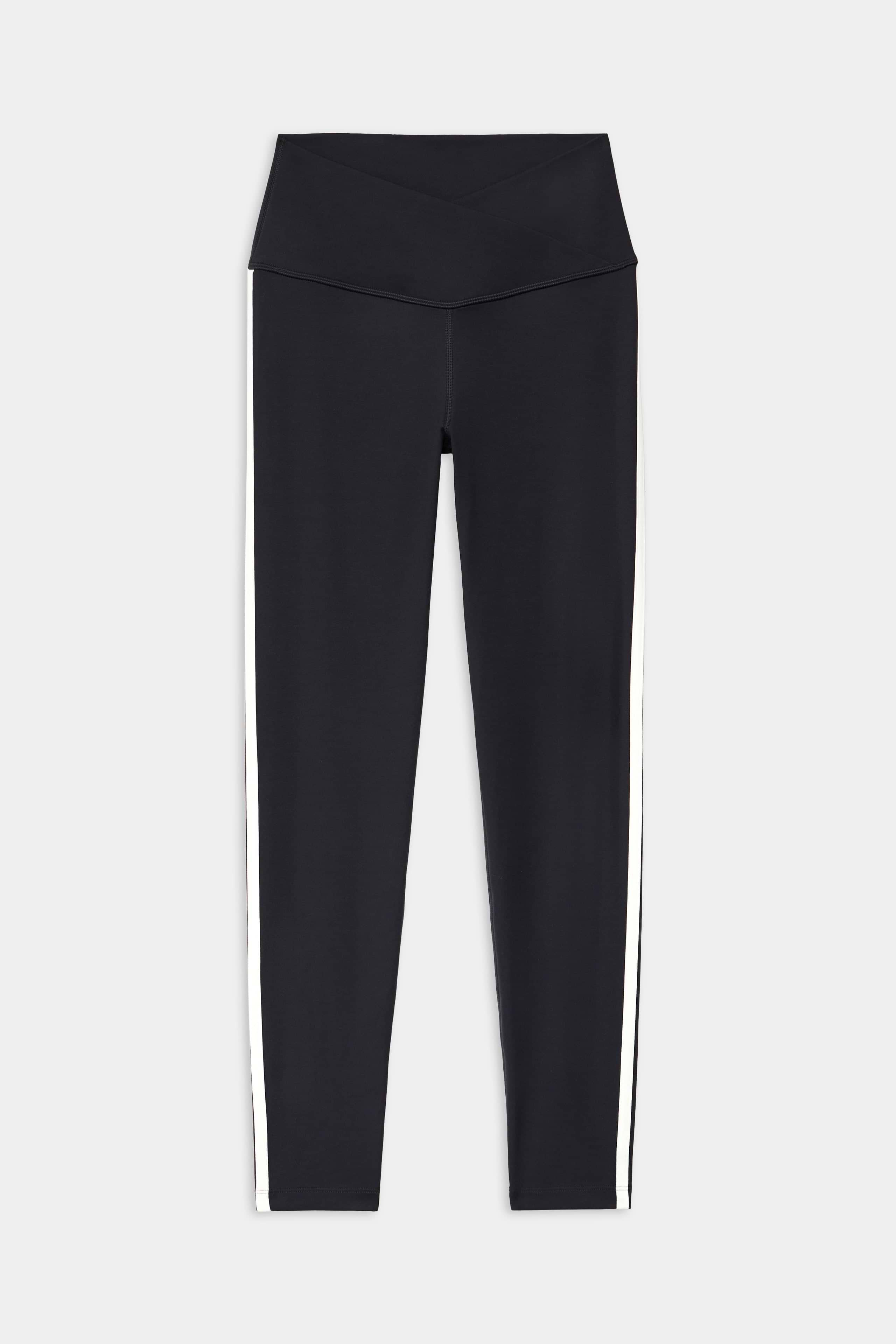 The SPLITS59 Mia Rigor Legging w/ Stripe in Black/White features black spandex and a wide crossover waistband with white vertical side stripes, shown against a plain white background.