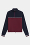 The SPLITS59 Millie Airweight Half Zip is a long-sleeve pullover featuring a navy top, burgundy bottom, white stripe, quarter zip, and zippered side pockets, shown on a white background.