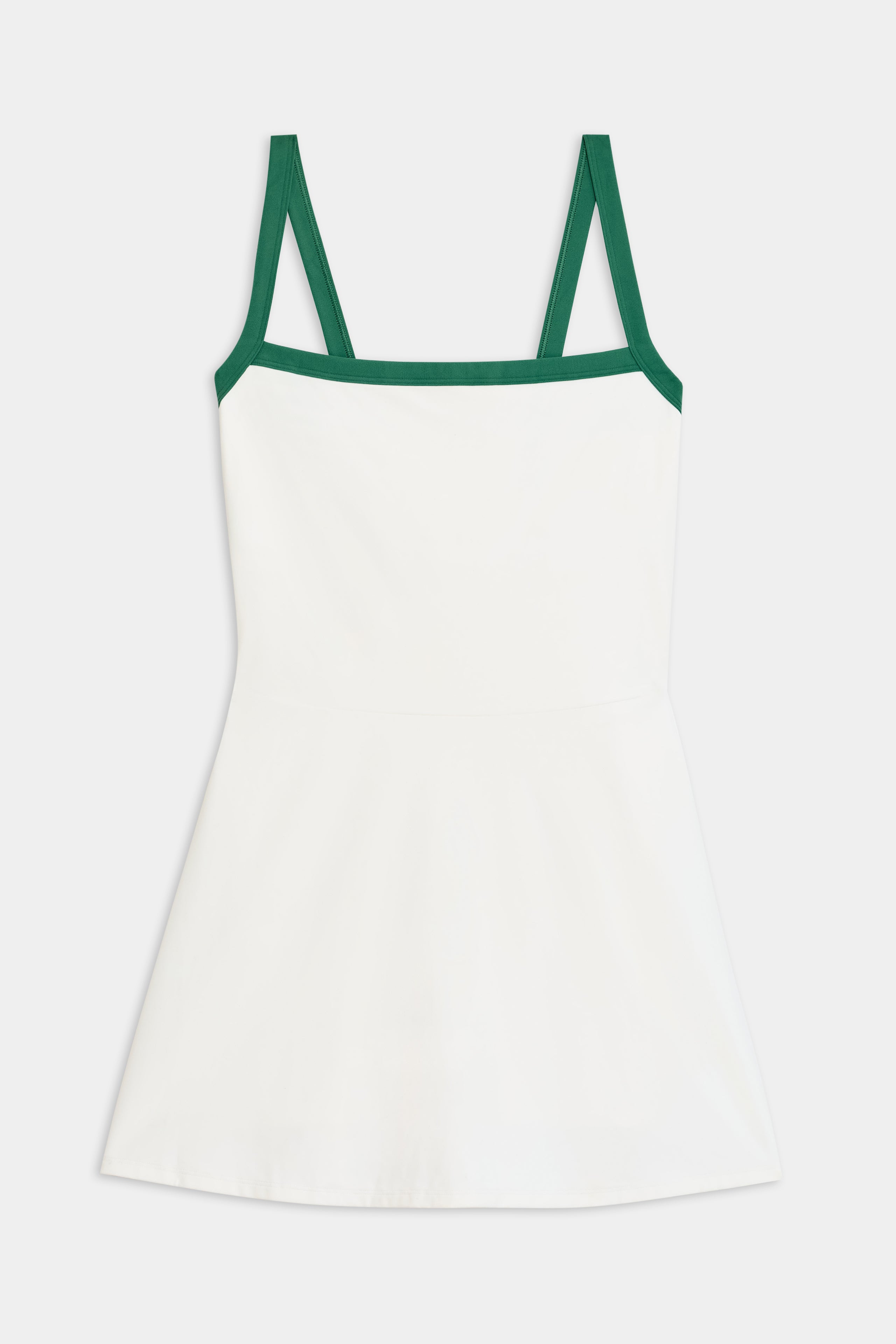 The Monah Rigor Dress by SPLITS59 in white/arugula showcases the iconic Monah silhouette with green shoulder straps and trim, set against a plain background.