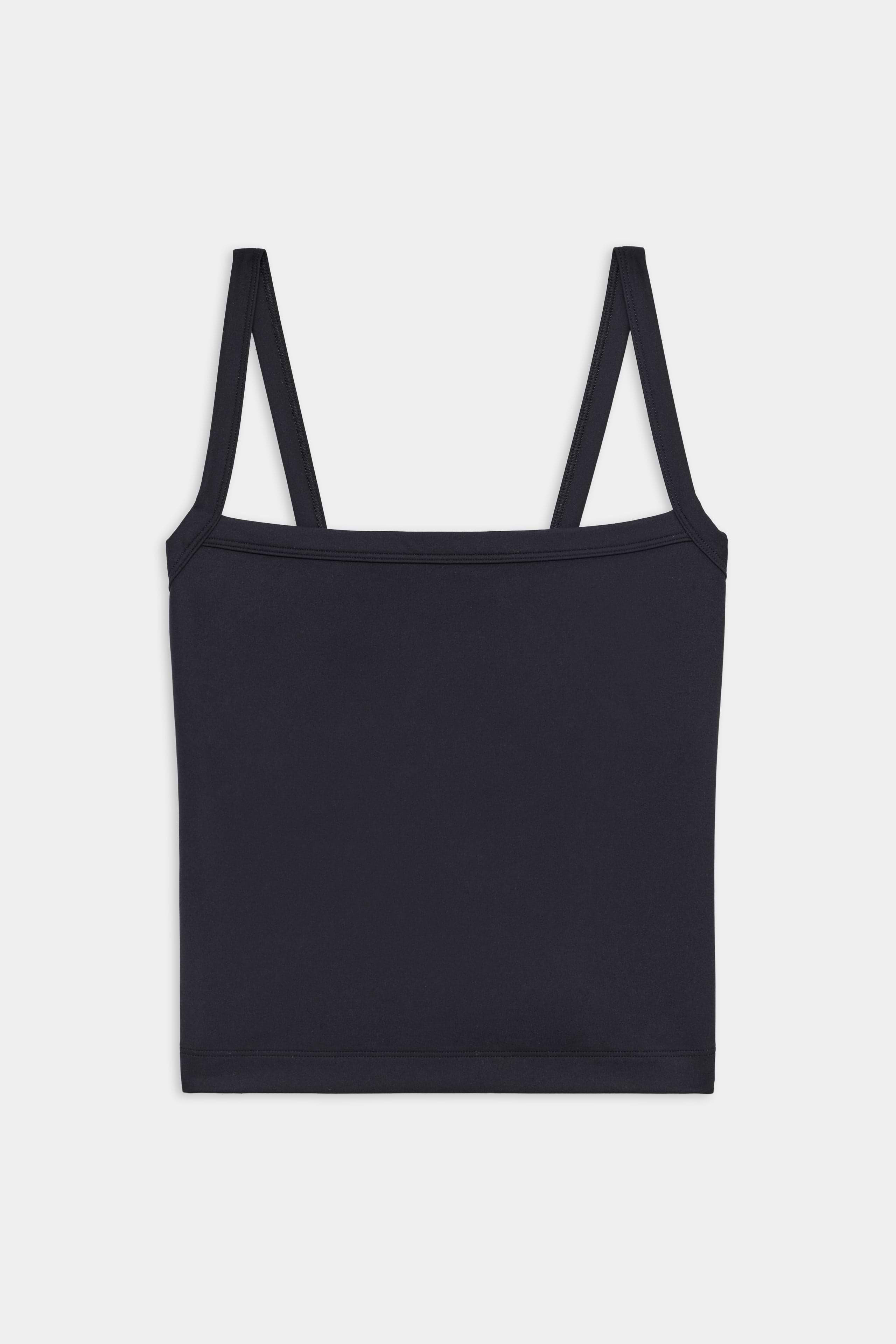 A plain black spaghetti strap tank top laid flat against a white background.