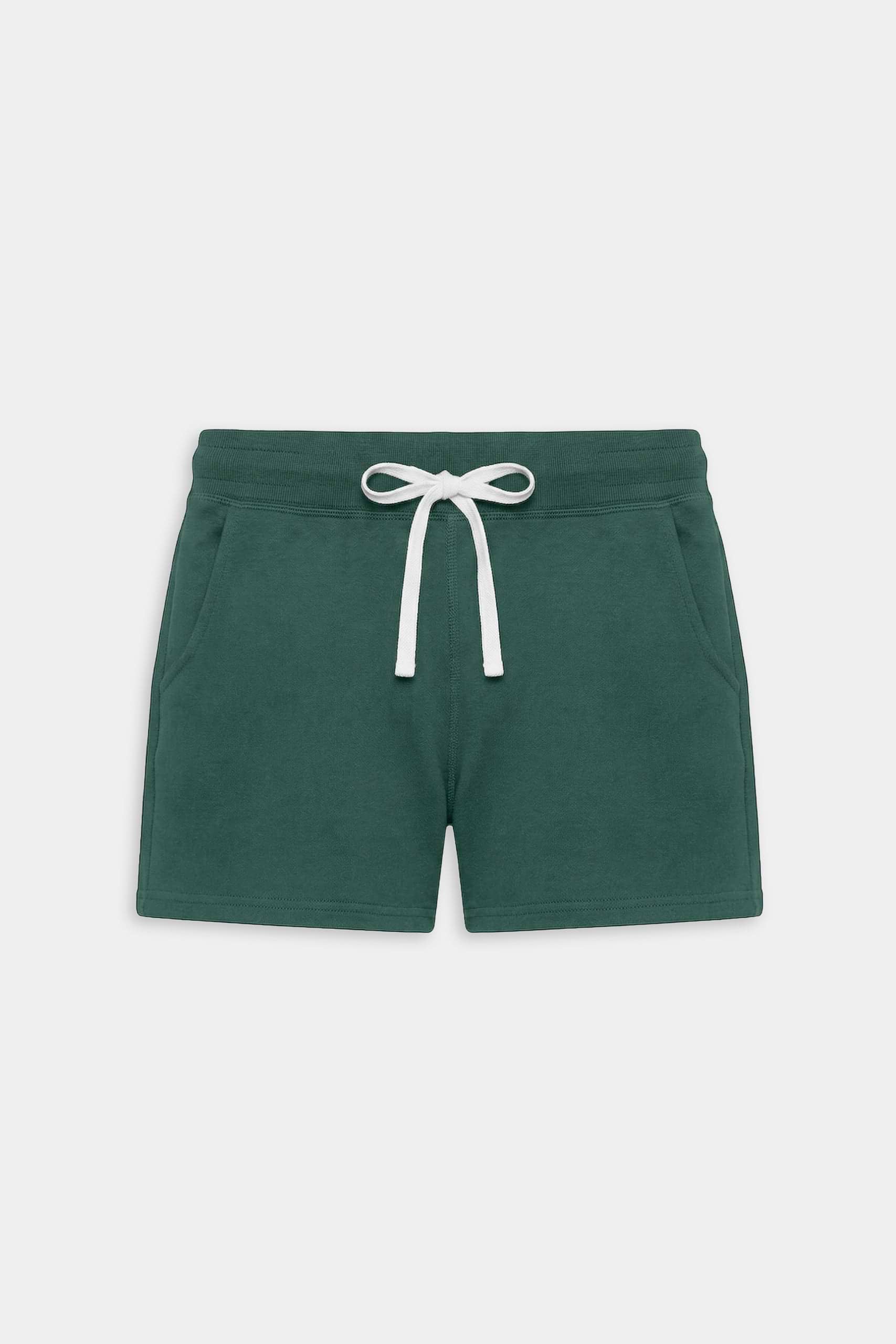 The SPLITS59 Reena Fleece Sweatshort in Arugula is a dark green mid-rise style made from ultra luxe fleece, featuring an elastic waistband, white drawstring, and two side pockets—ideal for cool weather workouts.