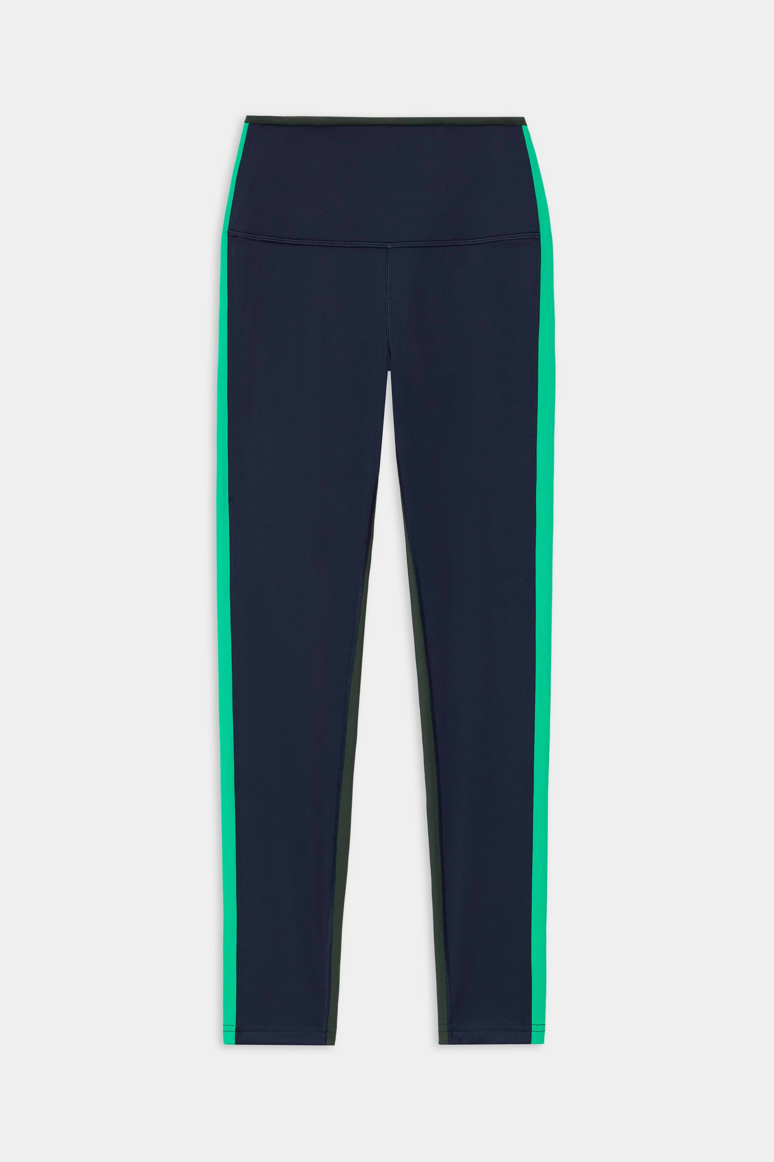 The Sam High Waist Rigor 7/8 leggings by SPLITS59 in Indigo/Spearmint feature a high waist, green side stripes, and are crafted from Rigor fabric with a 7/8 length, shown on a white background.