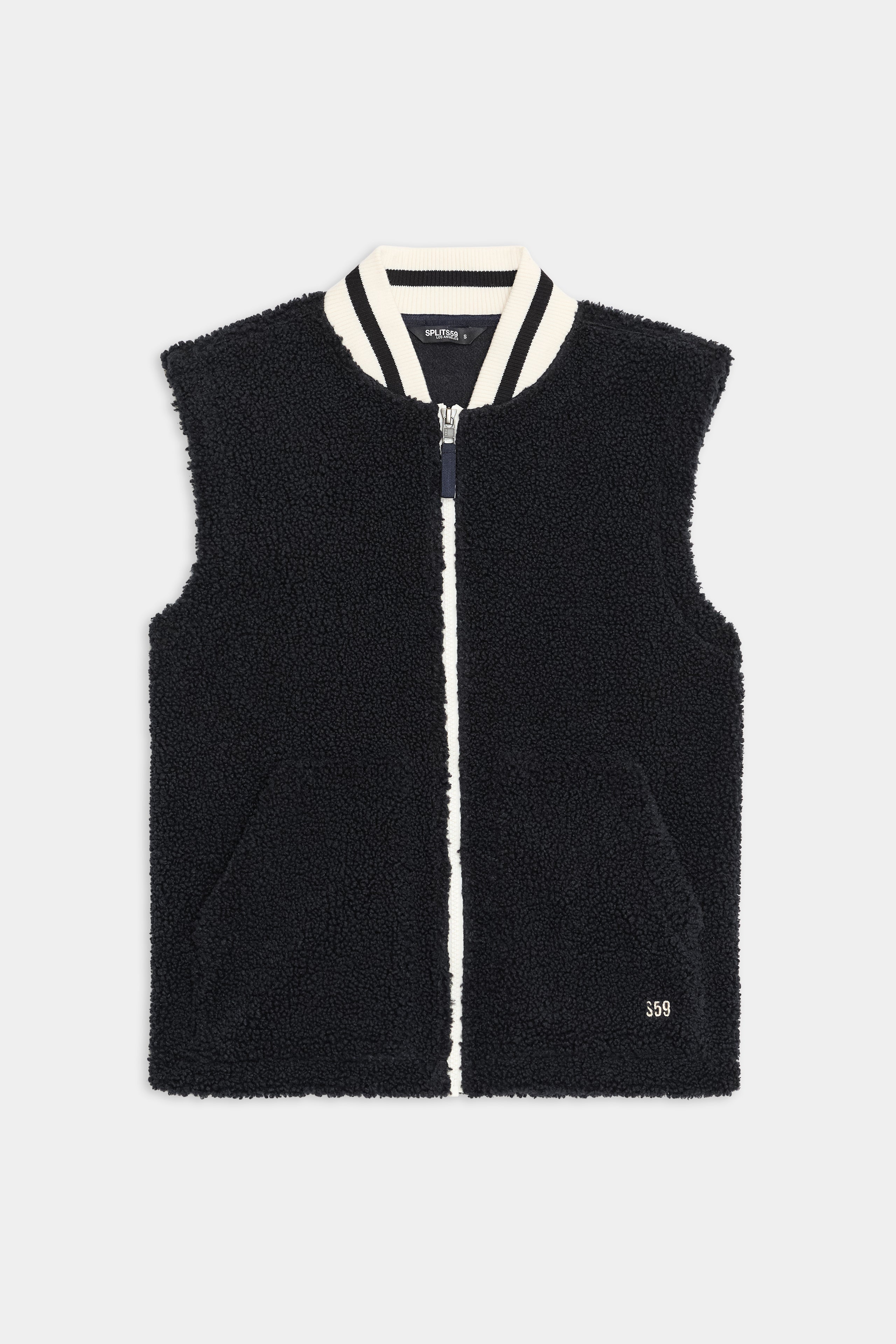 The SPLITS59 Aster Sherpa Vest in black features a white zip closure, two front pockets, and a white-striped collar, shown against a plain background.
