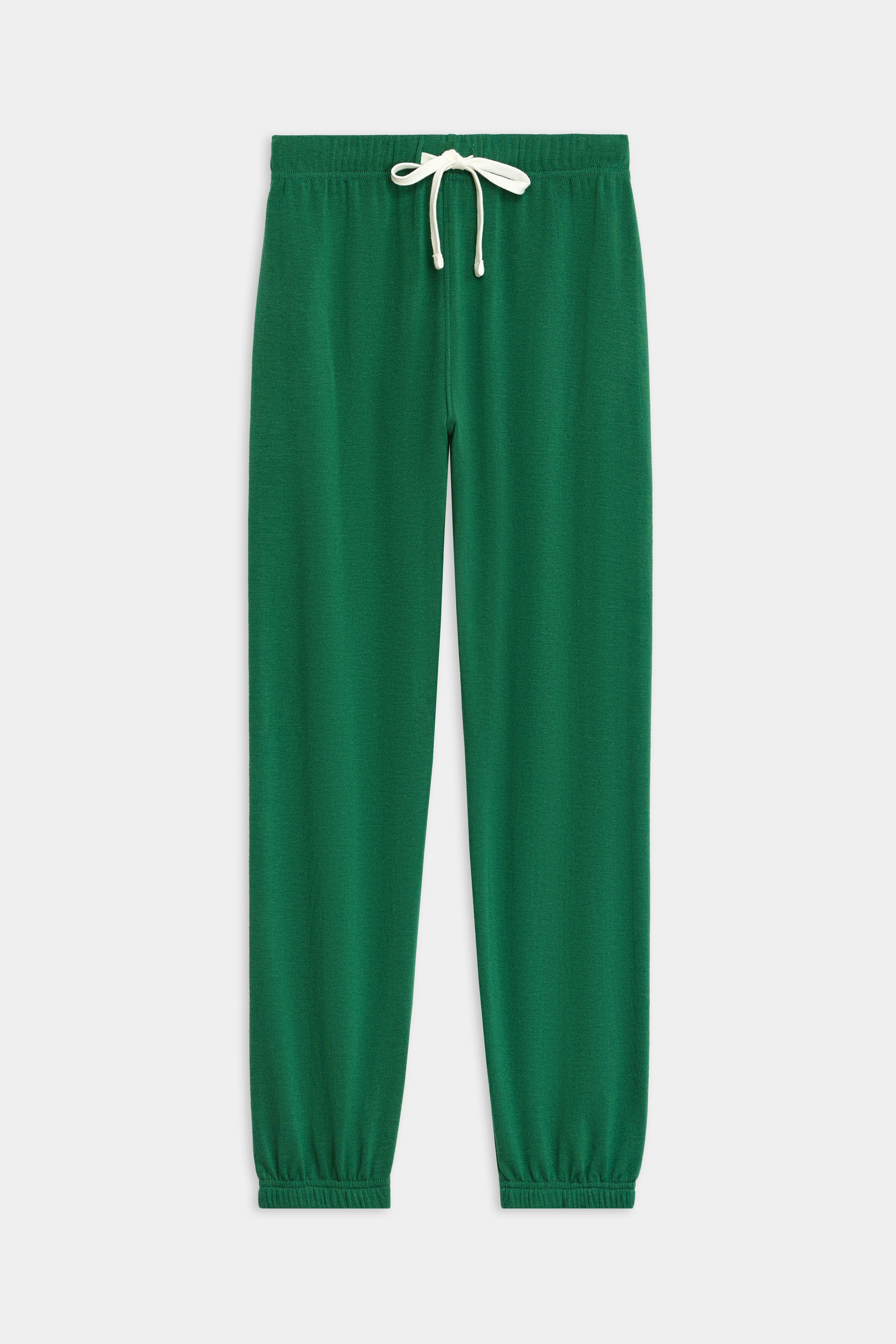 The Sonja Fleece Sweatpant - Arugula by SPLITS59, with a white drawstring and elastic cuffs, is made for cool weather workouts and showcased against a white background.