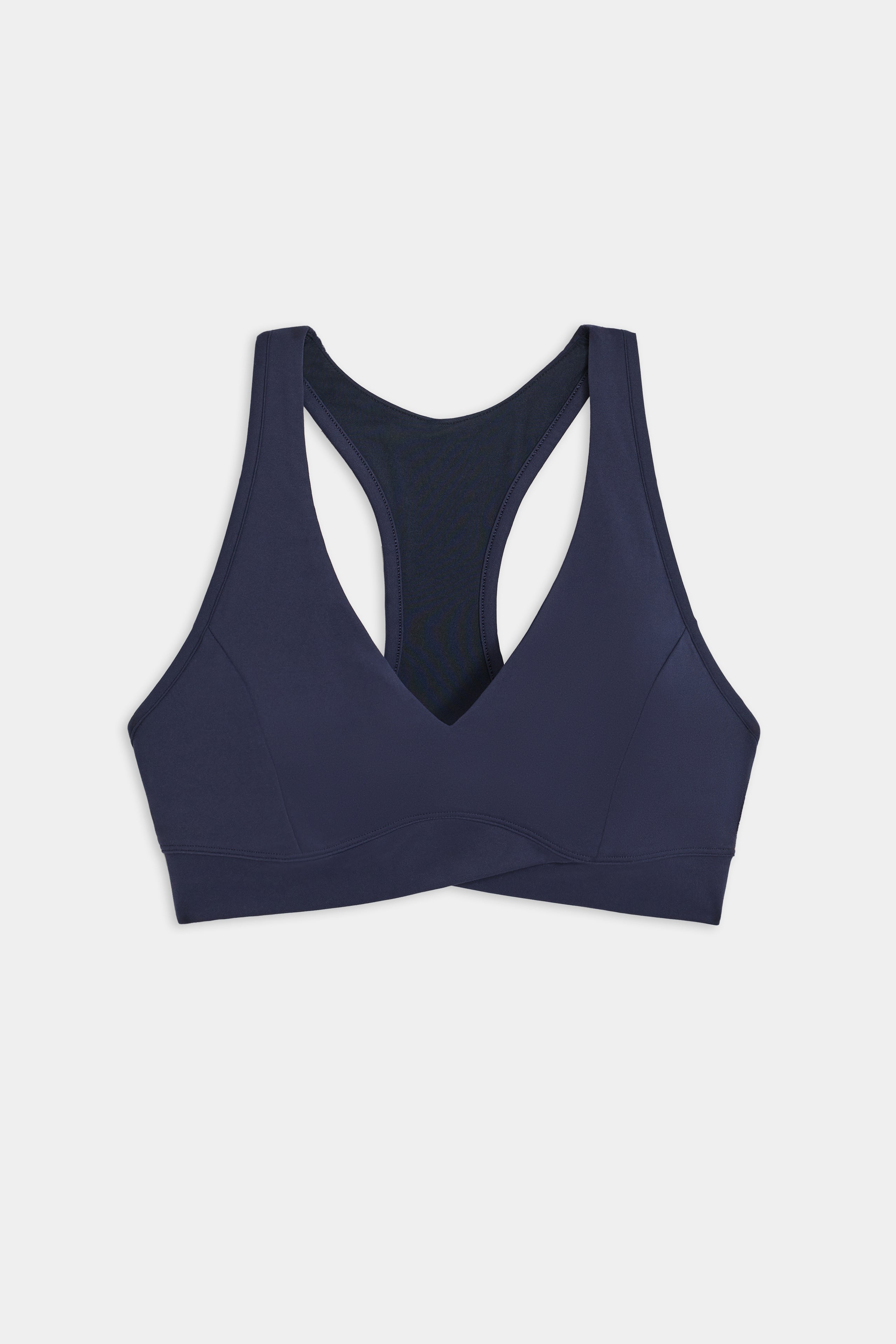 An indigo SPLITS59 Mia Rigor Bra, designed for multi-sport performance, is laid flat on a white background.