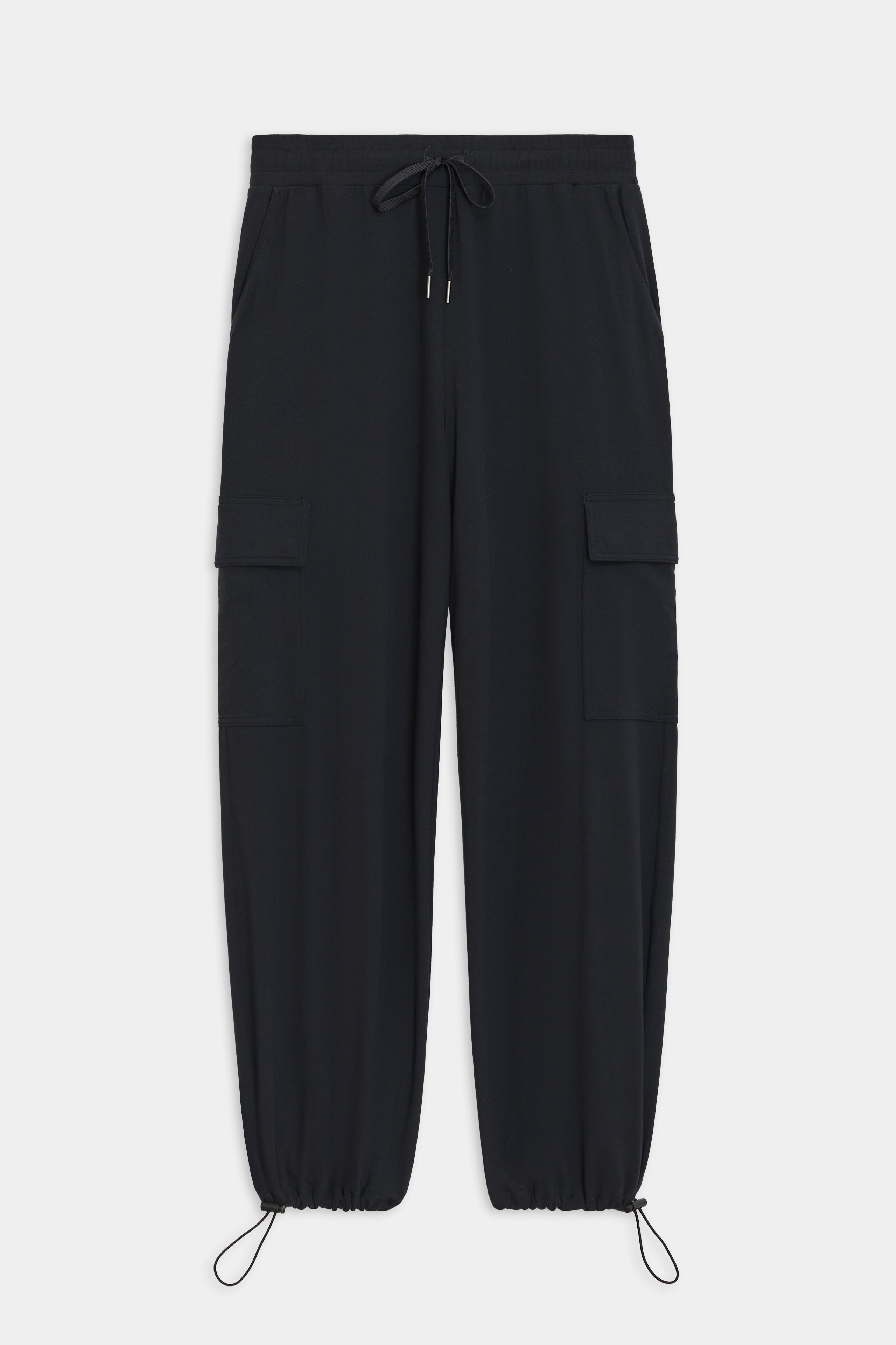 The Nico Airweight Cargo Pant by SPLITS59, in black, features a relaxed fit with side pockets and elastic cuffs. Made of lightweight Airweight fabric, these pants offer ultimate comfort and style for everyday wear, displayed flat on a white background.
