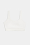 The SPLITS59 Sprint Rigor Bra - White is a sleeveless sports bra with a scoop neckline, perfect for gym workouts and multi-sport performance, showcased on a plain light background.
