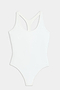 The SPLITS59 Suki Airweight Bodysuit in white is a soft nylon-spandex one-piece with a racerback design, shown on a flat white background.