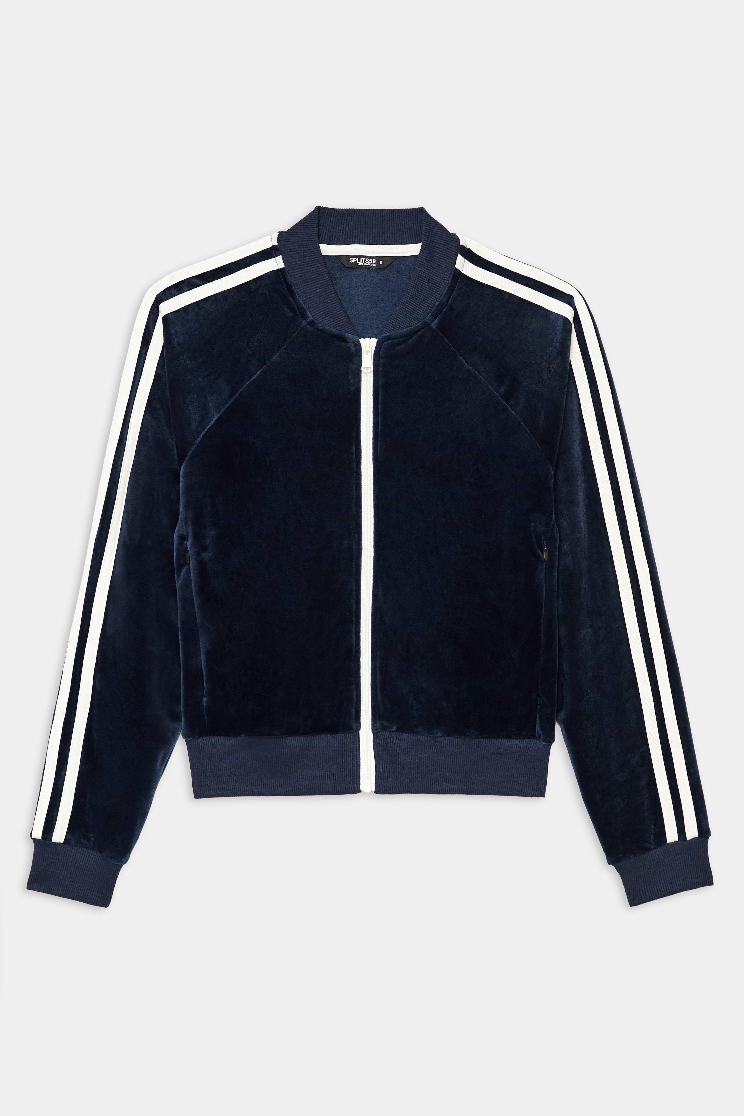 The SPLITS59 Heritage Velour Bomber in Indigo/White features a zip front, white sleeve stripes, ribbed cuffs and hem, and a soft velour texture.