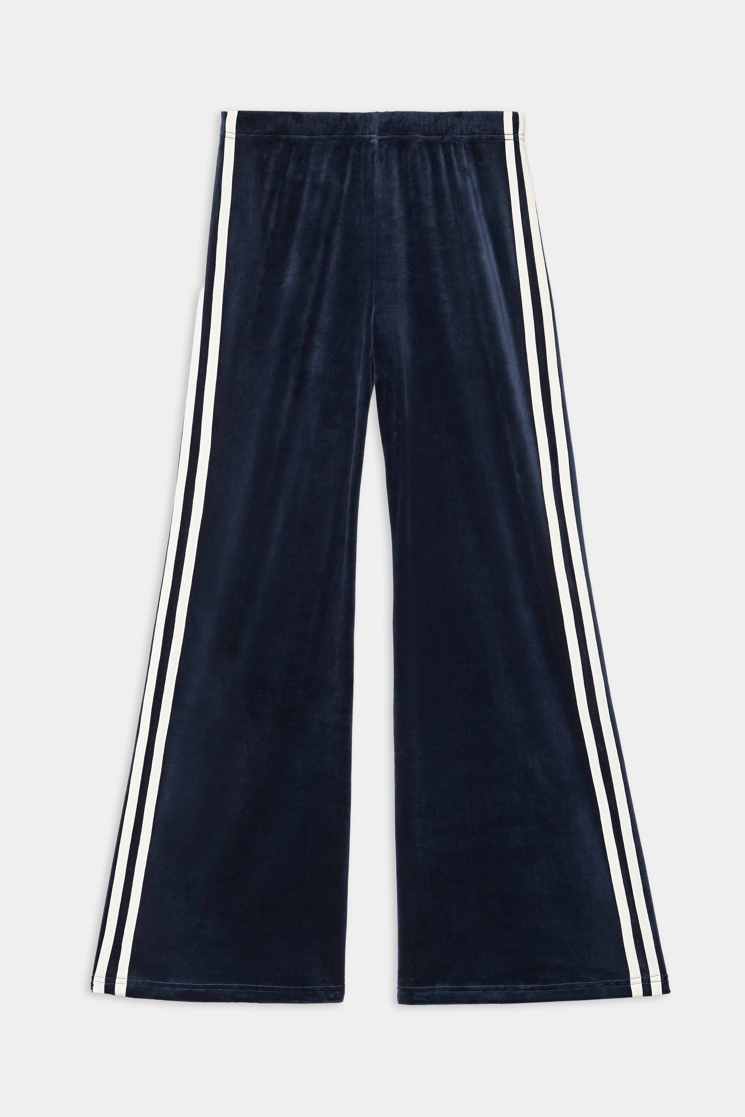 The SPLITS59 Heritage Velour Pant in Indigo/White features wide-leg styling, soft polyester-spandex fabric, and distinctive white double side stripes along the outer seams.