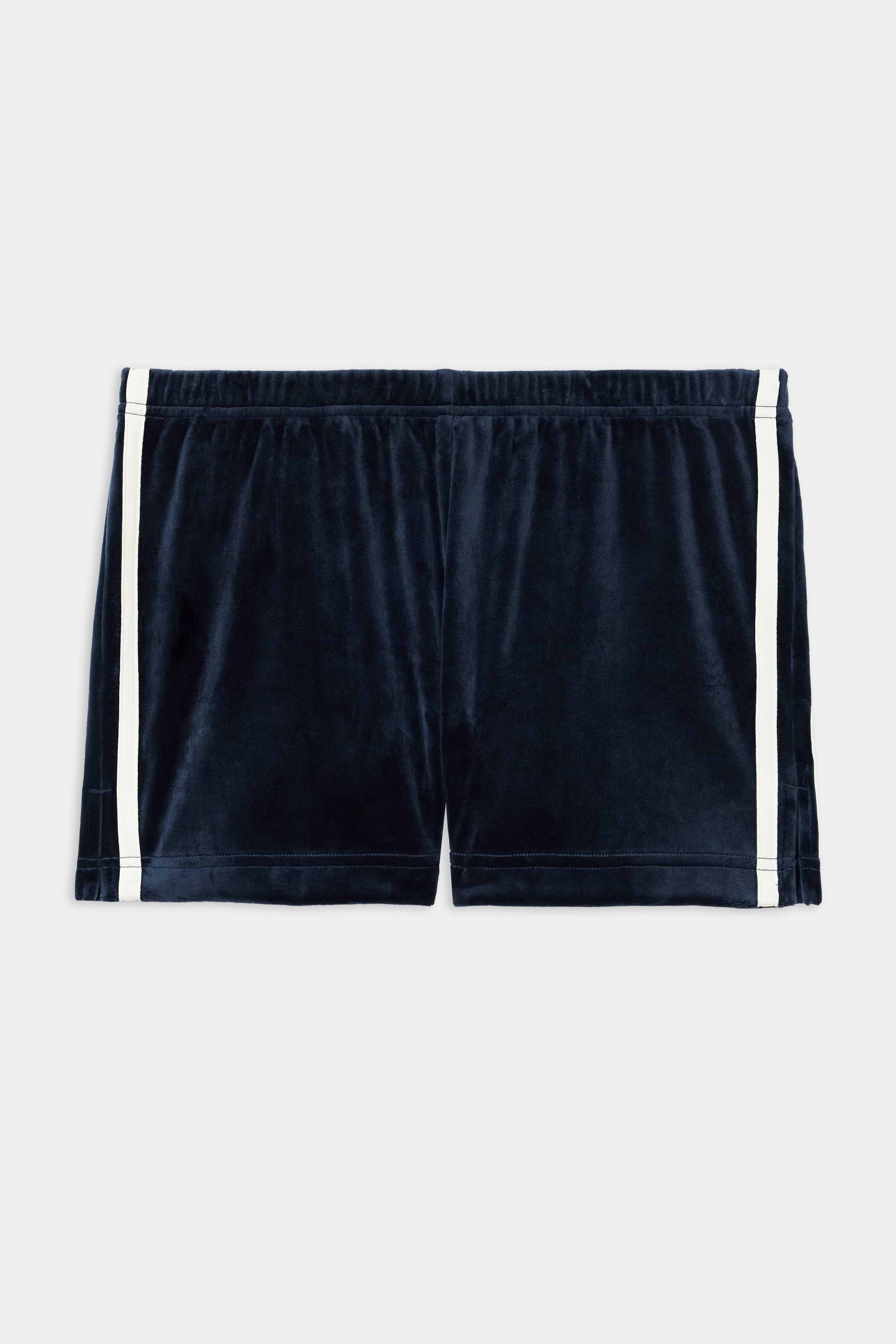 The SPLITS59 Heritage Velour Short in indigo/white features soft polyester-spandex fabric with white side stripes and is shown flat on a white background.